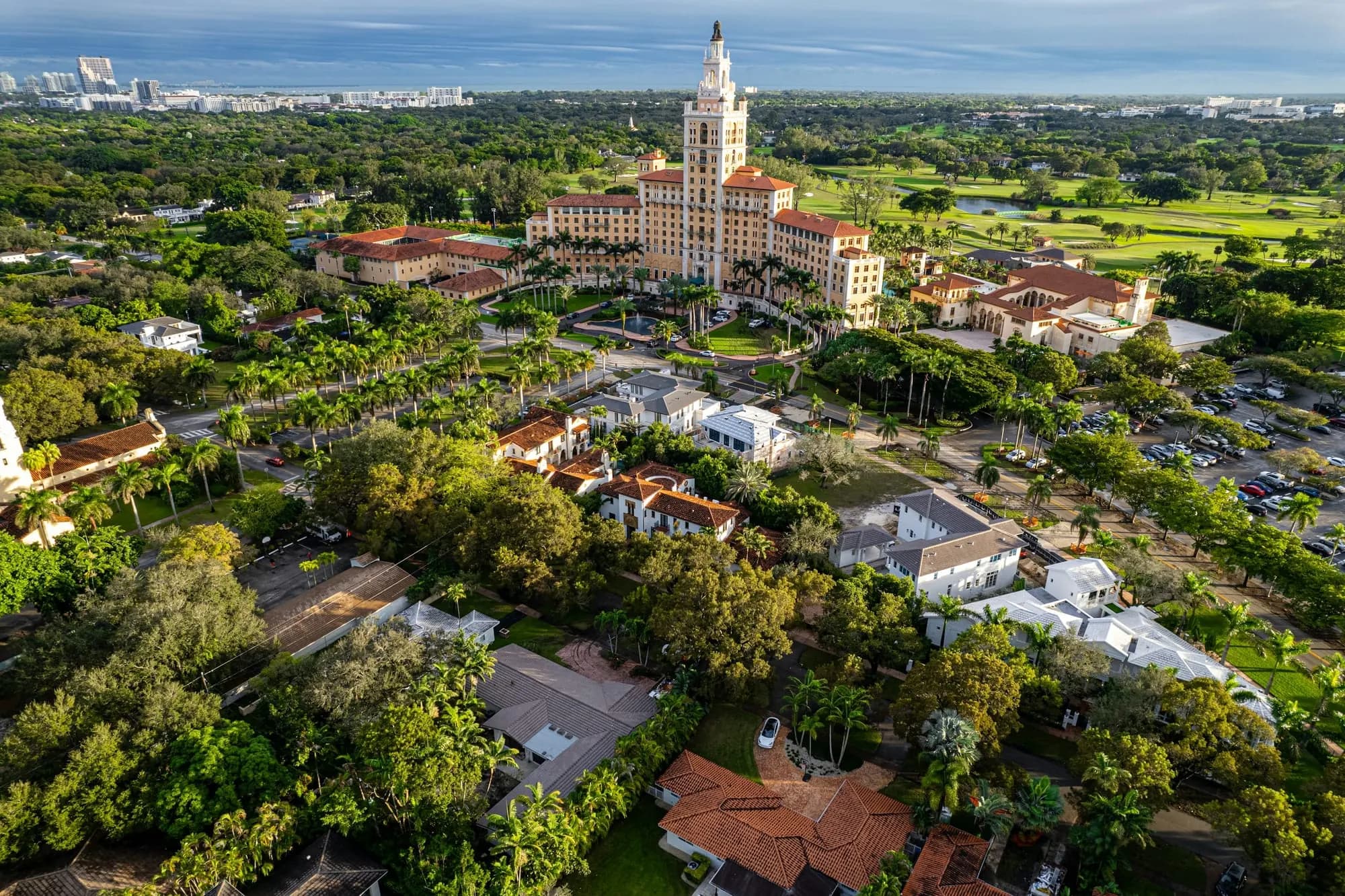 A tree-lined residential fabric, a golf course and a historic tower building — from the air